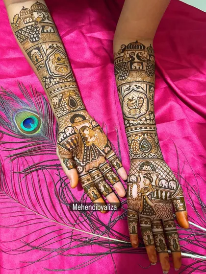 A closer look at the bride and groom portraits on the palms, surrounded by elephants and traditional patterns. Every line is drawn with care to bring the story to life.