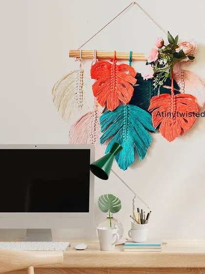 This monstera leaf wall hanging looks great in a home office, adding a splash of color and creativity above a desk.
