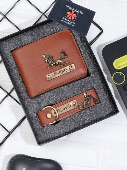 A brown leather wallet and keychain set, personalized with horse and bike charms.