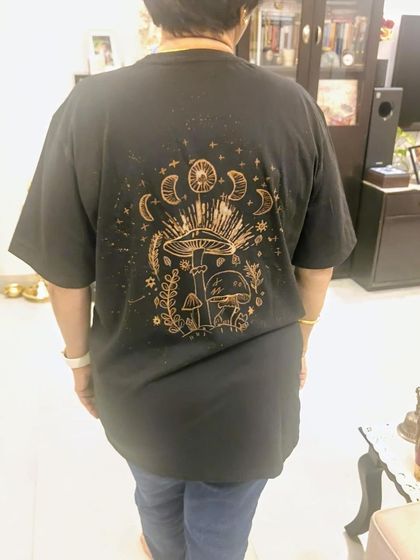 The back of a finished bleach art t-shirt, showcasing a beautiful and mystical mushroom design.