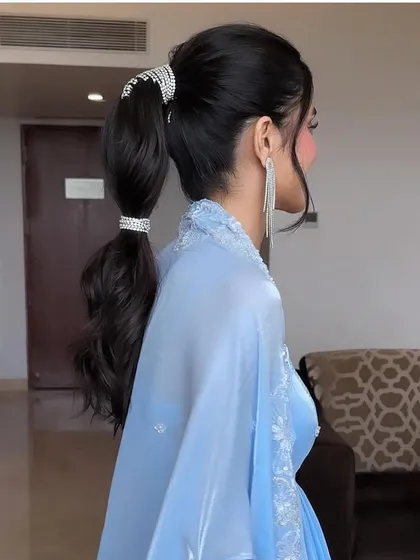 A side profile of the rhinestone-accented ponytail. This look is all about modern glamour and is sure to turn heads.