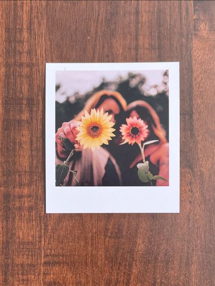 An artistic and creative polaroid of two friends holding sunflowers. This shows how you can turn any photo, no matter how creative, into a beautiful print.