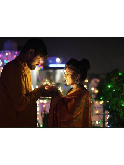 Another shot from the same series, focusing on the warm glow of the lights and the couple's interaction.