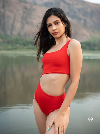 Another beautiful shot from the red swimsuit series, with the model looking back over her shoulder. The image has a classic and timeless feel.