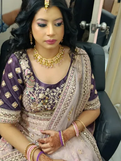A close-up of a gorgeous party makeup look we created. The soft pink and purple tones on the eyes and lips perfectly match her embroidered lehenga, creating a harmonious and elegant appearance.
