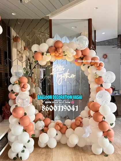 Balloon arches are a versatile way to decorate any space. This chic design uses a soft peach and white color palette for a modern and romantic engagement party entrance.