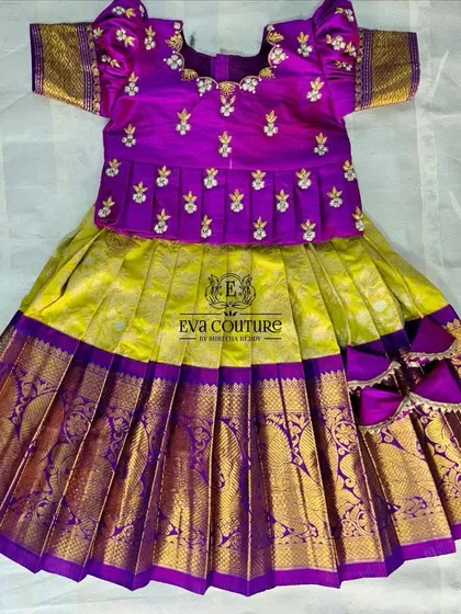A flat-lay of a yellow and purple Kanchi Pattu lehenga, perfect for a naming ceremony or first birthday.