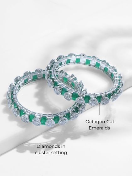 A detailed view of the Emerald Radiance Bangles, labeling the octagon-cut emeralds and the diamonds in their cluster setting.