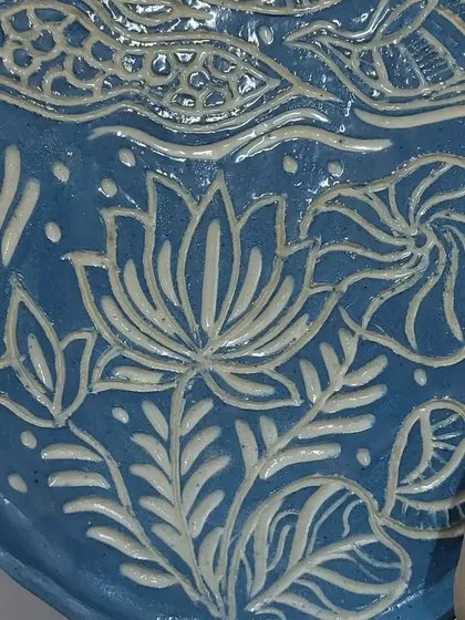 This plate features an embossed lotus design, created by carefully pressing textures into the clay. It's a technique I learned from a student, and I love the beautiful, intricate result.