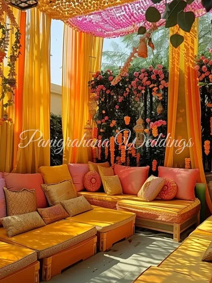 A different angle of the vibrant Mehendi seating area, showing the rich textures and colors of the custom fabrics and florals.