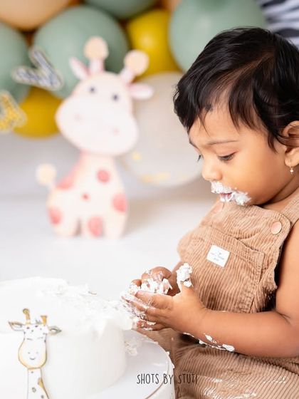 A close up of the cake investigation. The textures of the frosting and the baby's curious hands make for a great detail shot.