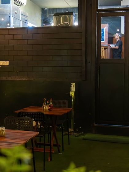 Our cozy outdoor seating at the Amar Colony outlet, perfect for a quick bite while you wait for your takeaway order.