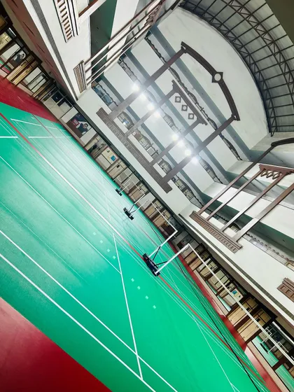 This angled shot captures the scale of our indoor badminton hall. The quality of the facility reflects the quality of the training we provide.