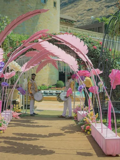 A beautiful pastel pink and floral entrance arch for a Haldi ceremony, creating a soft and romantic welcome.
