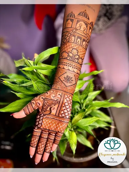 A full-arm bridal design with a focus on the backhand. The pattern includes architectural domes and peacock motifs.