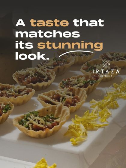 These bite-sized canapés in flaky pastry shells are filled with a savory mixture and topped with cheese, offering a taste that matches their stunning look.