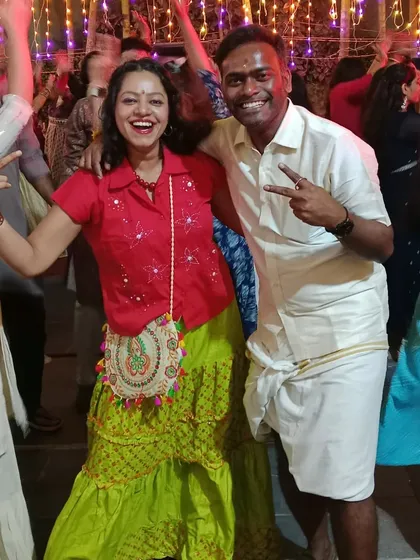 Enjoying the Dandiya night with a guest. My goal as a host is to connect with people and share in their joy, making the event feel like a celebration among friends.