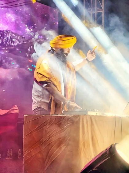 A dramatic shot of me surrounded by stage lights and smoke. I am proud of the journey and will never give up on my passion.