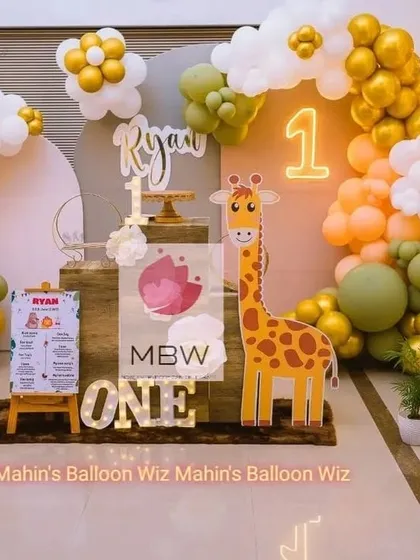 Another angle of the modern giraffe-themed first birthday, showcasing the full balloon arch and custom props that bring the celebration to life.