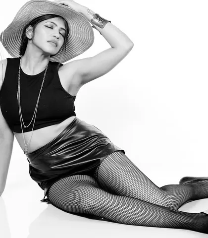 A black and white fashion shot with a wide-brimmed hat. The composition is playful yet chic, with a focus on the silhouette.
