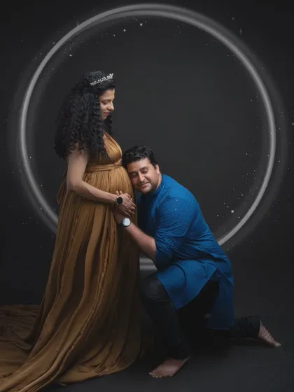 Listening to the whispers of a new life. This tender moment is framed by a glowing halo, symbolizing the sacred circle of family. It's a portrait that is both deeply personal and universally understood.