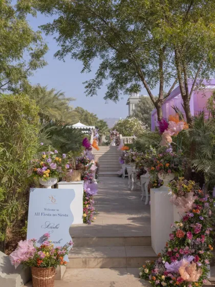 The floral-lined staircase leading up to the lavender-themed carnival, creating a beautiful and welcoming entrance for guests.