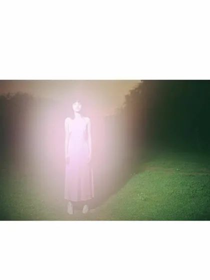 An experimental shot for Sruti Dalmia using a light flare effect. The styling is minimal, with the pink dress acting as a canvas for the ethereal, glowing light that envelops the model, creating a dreamlike and abstract fashion portrait.