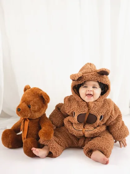 The biggest, happiest grin from a seven-month-old baby dressed as a teddy bear. These themed shoots are all about capturing pure joy.