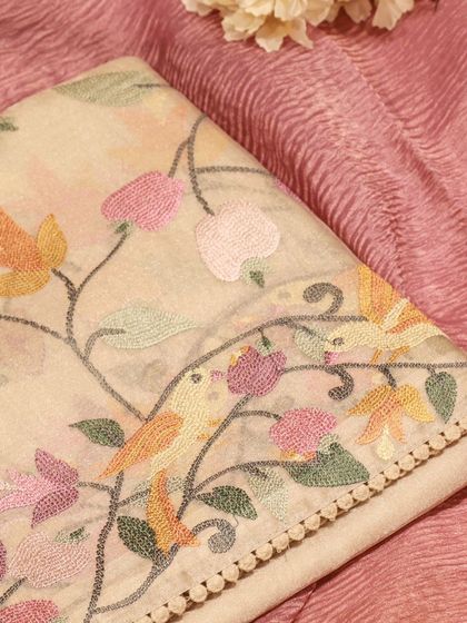 A close-up of the fine embroidery, a testament to the skill of the artisans we work with.