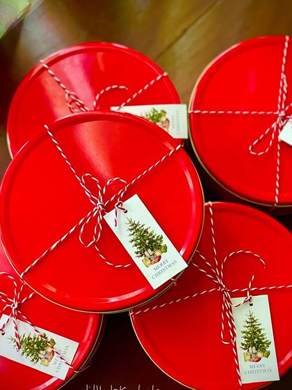 The signature red tins for my rum plum and non-alcoholic plum cakes, all tied up and ready to go. These have been flying off the shelf.
