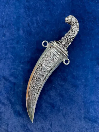 The silver dagger fully sheathed, showcasing its curved shape and the fine craftsmanship of the scabbard. It's a unique gift for collectors or a statement decor piece.
