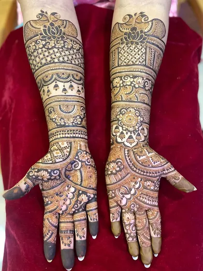 This design for an engagement features a mix of lotuses, checks, and flowing vines, covering the hands and arms in beautiful detail.
