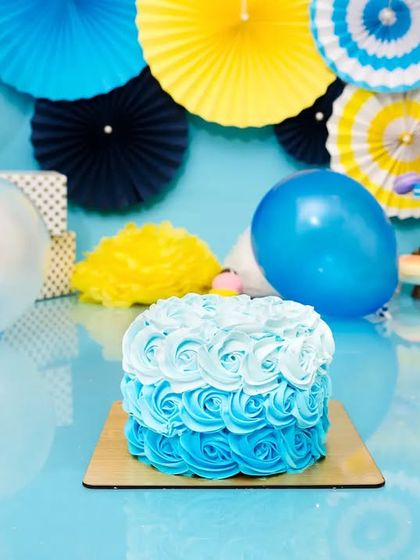 The calm before the storm! A beautiful blue ombre cake sits ready for a first birthday cake smash session.