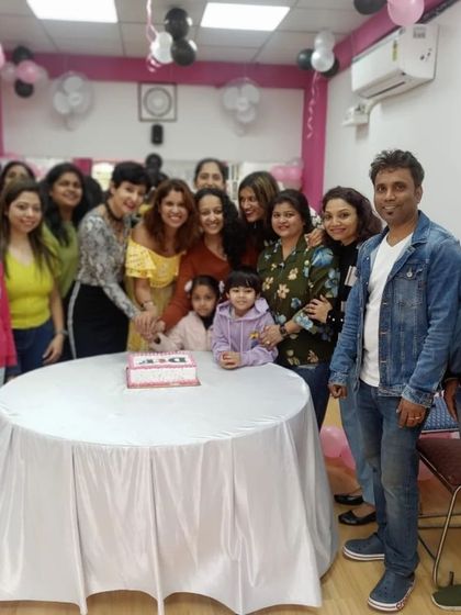 Celebrating the new studio with a cake-cutting ceremony. It's a sweet start to a new fitness hub.