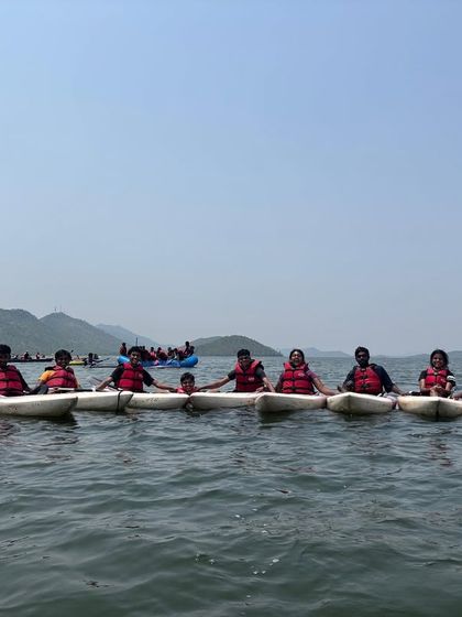 A team of kayakers links their boats together for a group photo on the vast waters of Vani Vilas Sagara.