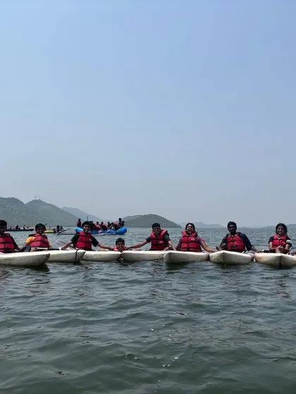 Participants in single kayaks hold onto each other, creating a stable line on the water. This is a great team-building exercise we use to help beginners get comfortable.