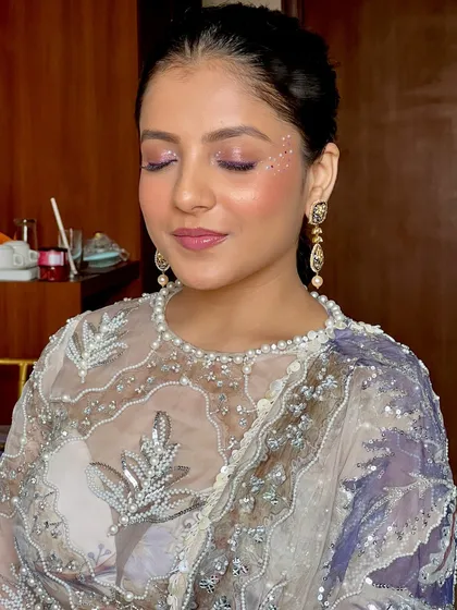 A close-up of the purple sparkle eye makeup. The glitter is strategically placed to catch the light and create a mesmerizing effect.