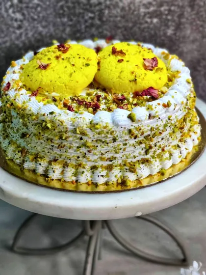 This is my signature Rasmalai Cake, a true celebration in every bite. I craft it with a soft, saffron-infused sponge, layer it with creamy rabdi, and top it with delicate rasgullas. It’s a perfect example of how I blend traditional Indian desserts with modern baking.