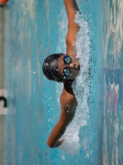 Perfecting the backstroke. This shot captures the precise body rotation and arm extension we teach to maximize power and speed in every stroke.