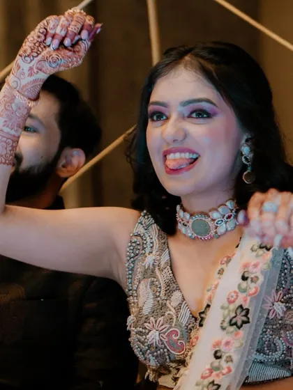 A candid shot of the bride enjoying herself and dancing at her Sangeet.