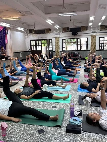 Celebrating International Yoga Day with our wonderful community. Here, students are practicing Supta Padangusthasana (Reclining Hand-to-Big-Toe Pose) to open the hamstrings.