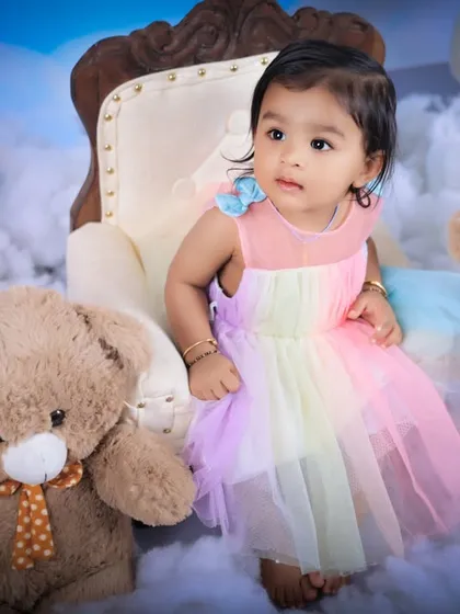 A sweet, thoughtful expression from the little girl in our clouds and teddy bears setup. The soft lighting and dreamy background create a magical portrait.