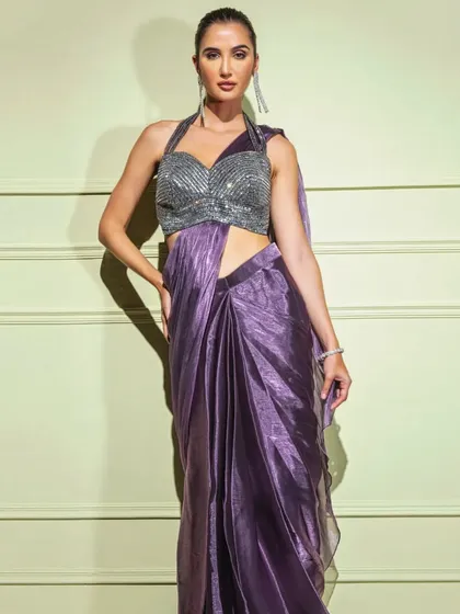 A full-length shot of the metallic purple drape saree, emphasizing its vibrant color and glamorous appeal.