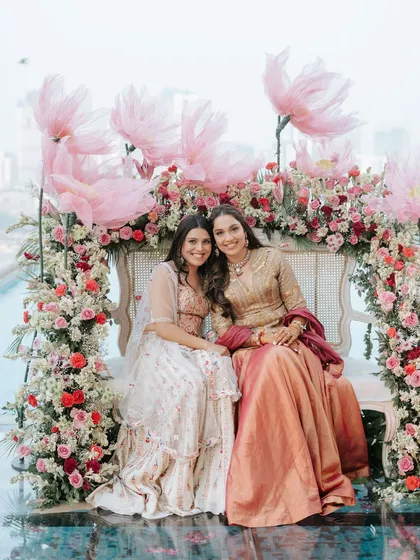 The bride with her friends, all smiles in front of the romantic and picturesque floral photo-op we created.