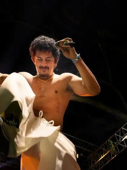 Caught mid-air, this action shot captures the dynamic and physical performance style of Hanumankind.