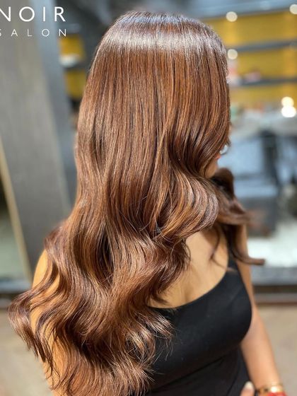 A side view of this stunning brunette look, highlighting the seamless blend of colors and the healthy condition of the hair.