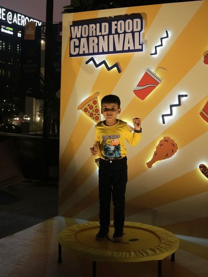 A young guest having a blast on the trampoline at our World Food Carnival. We ensure there are plenty of fun activities and photo opportunities for kids and adults alike.