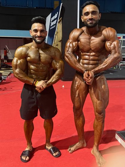 Front double bicep with another champion.