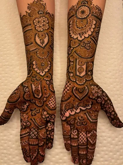 The full symmetrical design, held up to show the beautiful heart shapes created when the palms are brought together.