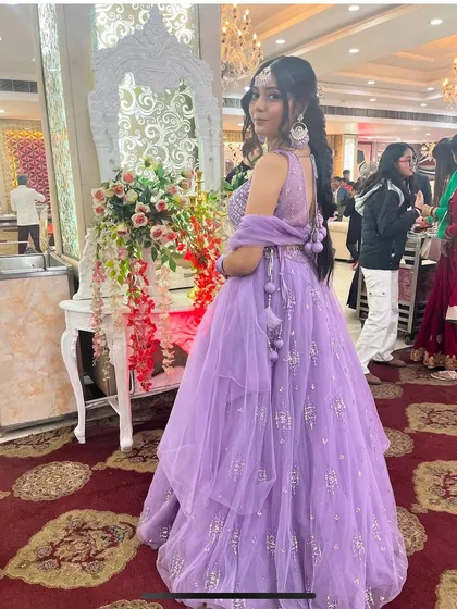 A lovely shot of our client in a lavender net lehenga. The tiered skirt and delicate embroidery make it a dreamy and youthful choice for a wedding guest or bridesmaid.